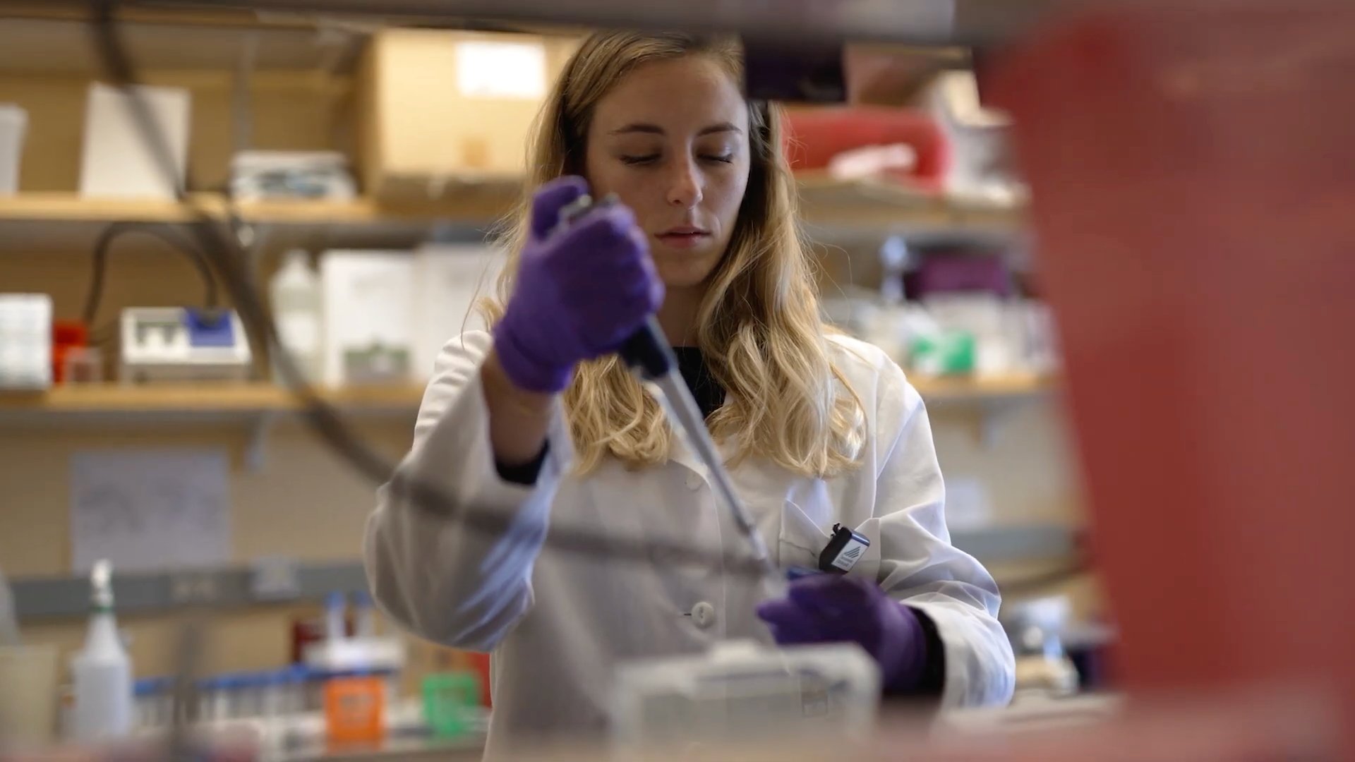 Person putting material into a test tube