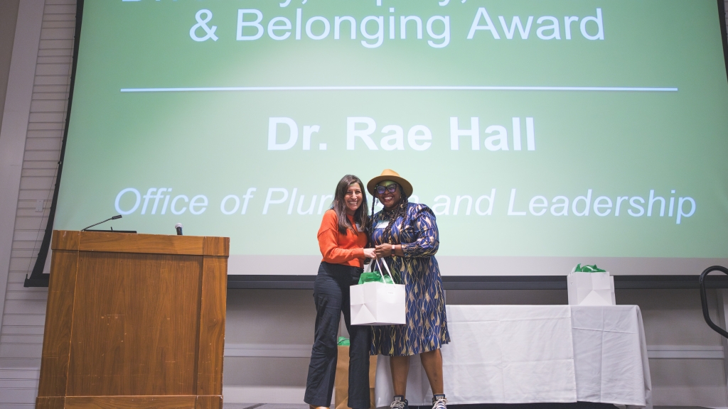 Rae Hall accepting an award from Jennifer Rosales